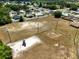 Overhead shot of a neighborhood field, including a playground, baseball field, soccer goals, bordered by trees and houses at 4680 Sw 142 Place Rd, Ocala, FL 34473