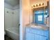 Bathroom boasts a vanity with granite countertop, white sink and white tiled shower at 4680 Sw 142 Place Rd, Ocala, FL 34473