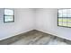 Bedroom features two windows and wood-look vinyl flooring at 4680 Sw 142 Place Rd, Ocala, FL 34473