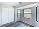 Bright bedroom features vinyl floors, neutral paint, and a window with natural light at 4680 Sw 142 Place Rd, Ocala, FL 34473