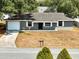 Cozy home with a gray exterior, garage, and a well-manicured front yard at 4680 Sw 142 Place Rd, Ocala, FL 34473