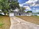 View of home with a driveway leading to the front of the residence at 4680 Sw 142 Place Rd, Ocala, FL 34473