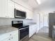 This modern kitchen features stainless steel appliances, granite counters, and ample cabinet space at 4680 Sw 142 Place Rd, Ocala, FL 34473