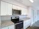 This updated kitchen features stainless steel appliances, granite countertops, and ample cabinet space at 4680 Sw 142 Place Rd, Ocala, FL 34473