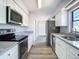 Updated kitchen featuring granite countertops, stainless steel appliances, and white cabinetry at 4680 Sw 142 Place Rd, Ocala, FL 34473