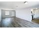 Spacious living room featuring modern flooring and views into the adjacent kitchen at 4680 Sw 142 Place Rd, Ocala, FL 34473