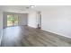 Open-concept living room with modern flooring and a sliding glass door for natural light at 4680 Sw 142 Place Rd, Ocala, FL 34473