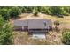 An aerial shot shows a home's rear featuring a covered patio and what looks like a retro shuffleboard court at 5155 Holopaw Rd, St Cloud, FL 34773
