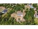 An aerial shot highlights a charming home surrounded by mature trees, offering both privacy and natural beauty at 5155 Holopaw Rd, St Cloud, FL 34773