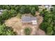 Aerial view of a single-story brick home featuring an attached two-car garage, surrounded by sparse landscaping at 5155 Holopaw Rd, St Cloud, FL 34773