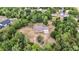 The home sits in a lush, wooded area on a large lot. A 2-car garage is attached at 5155 Holopaw Rd, St Cloud, FL 34773
