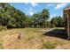 Expansive backyard with mature trees and a basketball court for outdoor enjoyment at 5155 Holopaw Rd, St Cloud, FL 34773