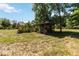 Spacious backyard featuring a gazebo structure, mature trees, and ample space for outdoor activities at 5155 Holopaw Rd, St Cloud, FL 34773