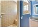 Full bathroom featuring tiled walk-in shower, bench and window to the vanity at 5155 Holopaw Rd, St Cloud, FL 34773