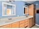 Bathroom featuring double sink vanity with cabinet storage and framed mirrors at 5155 Holopaw Rd, St Cloud, FL 34773