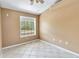 Bright bedroom with tile flooring and a large window offering great outdoor views at 5155 Holopaw Rd, St Cloud, FL 34773