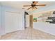 Spacious bedroom featuring tiled floors, fan and unique wall art, offering style and comfort at 5155 Holopaw Rd, St Cloud, FL 34773