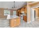 Open kitchen with large island, bright cabinets, and modern lighting at 5155 Holopaw Rd, St Cloud, FL 34773