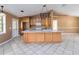 Open kitchen with wood cabinets, a center island, and tile flooring, creating a functional and stylish cooking space at 5155 Holopaw Rd, St Cloud, FL 34773