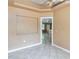 Open-concept living room with decorative ceiling and tile flooring at 5155 Holopaw Rd, St Cloud, FL 34773