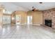 Spacious living room with a brick fireplace, tile flooring, and multiple entryways creating an open and airy feel at 5155 Holopaw Rd, St Cloud, FL 34773