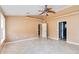 Bright and airy living room with ceiling fan and access to other rooms at 5155 Holopaw Rd, St Cloud, FL 34773