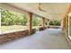 Large, covered outdoor patio featuring brick columns and concrete flooring, perfect for entertaining and enjoying the outdoors at 5155 Holopaw Rd, St Cloud, FL 34773