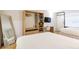 Modern bedroom includes a closet with microwave, safe, mirror, and desk area at 5245 W Irlo Bronson Memorial Hwy # 113, Kissimmee, FL 34746