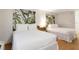 Comfortable bedroom featuring two beds with white linens and bamboo leaf artwork at 5245 W Irlo Bronson Memorial Hwy # 113, Kissimmee, FL 34746