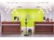 Hotel reception area with lime green accent wall and 2 wood-trimmed check-in counters at 5245 W Irlo Bronson Memorial Hwy # 113, Kissimmee, FL 34746