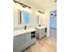 Bathroom features a double sink vanity with modern fixtures, granite countertops, and tile backsplash at 5704 Sw 108Th St, Ocala, FL 34476