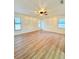 Spacious bedroom featuring new light wood floors, ceiling fan, and plentiful natural light at 5704 Sw 108Th St, Ocala, FL 34476