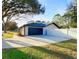 Spacious two-car garage with a large driveway and fenced yard, perfect for extra parking and privacy at 5704 Sw 108Th St, Ocala, FL 34476