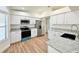 Modern kitchen with stainless steel appliances, granite countertops, and sleek white cabinetry at 5704 Sw 108Th St, Ocala, FL 34476