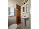 Bright bathroom features a pedestal sink, and a walk-in shower with tiled walls at 6124 Fox Hunt Trl, Orlando, FL 32808