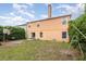 Backyard featuring large lawn, mature trees, and a basketball hoop at 709 Crystal Bay Ln, Orlando, FL 32828