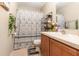 Bathroom featuring a shower with patterned curtains and tiled floors at 709 Crystal Bay Ln, Orlando, FL 32828