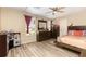Comfortable bedroom with laminate floors, ceiling fan, and large dresser at 709 Crystal Bay Ln, Orlando, FL 32828