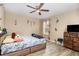 Comfortable bedroom with a ceiling fan, window, and natural light at 709 Crystal Bay Ln, Orlando, FL 32828