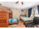 Fun bedroom with a bunk bed and additional bed, ceiling fan and wood floors at 709 Crystal Bay Ln, Orlando, FL 32828