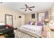 Cozy bedroom with decorative mirror, ceiling fan, plush rug, and decorative pillows at 709 Crystal Bay Ln, Orlando, FL 32828