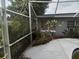 Inviting backyard featuring mature landscaping and a screened-in pool area at 7406 Nolton Way, Orlando, FL 32822