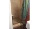This bathroom features a tiled shower with river rock floor and safety grab bar at 7406 Nolton Way, Orlando, FL 32822