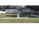 Charming single-story home features a landscaped front yard with healthy green grass and tidy walkways at 7406 Nolton Way, Orlando, FL 32822