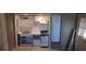Compact kitchen with essential appliances, cabinets, and a functional layout at 7406 Nolton Way, Orlando, FL 32822