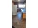 View of the kitchen featuring tile flooring, an old refrigerator, a sink, and a window at 7406 Nolton Way, Orlando, FL 32822