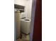 This laundry room features a modern washing machine and a utility sink for convenience at 7406 Nolton Way, Orlando, FL 32822