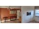Living room featuring a ceiling fan, lighting, and access to a door at 7406 Nolton Way, Orlando, FL 32822