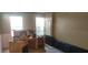 Bright living room showcasing an old desk and multiple windows that let in natural light at 7406 Nolton Way, Orlando, FL 32822