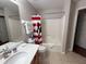 A clean, well-maintained bathroom with a shower-tub combination, a vanity, and tile flooring at 8457 Secret Key Cove, Kissimmee, FL 34747